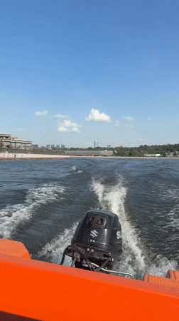 Orange boat travels across water near Kazan, Russia
