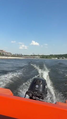 Orange boat travels across water near Kazan, Russia