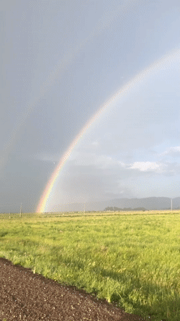 Rainbow over rural Siberian fields after a passing storm