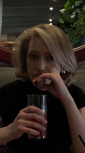 Woman documents dining experience at busy Ufa restaurant