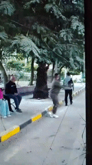 Figure in black jacket walks away carrying a backpack