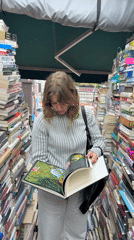 Woman browses books at Seoul outdoor stall early morning