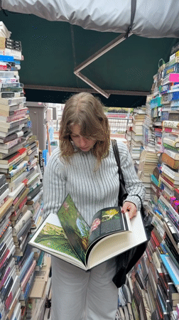 Woman browses books at Seoul outdoor stall early morning