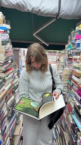 Woman browses books at Seoul outdoor stall early morning