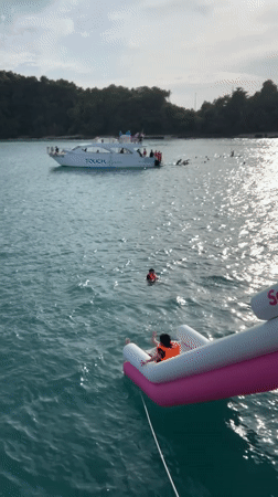 Jumping into the sea off an inflatable slide in Rawai