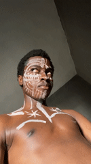 Man photographed with decorative facial adornments in Onitsha, Nigeria