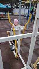 Children play at Chaikovsky park amid sculptures and windmill