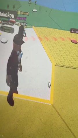 The video shows a first-person perspective of someone playing a video game. The game appears to be a simulation or strategy game set on a map, possibly a world map with different regions highlighted.

**Subjects:**
*   **People:** The primary visible subject is an avatar of a person in the game, depicted as a stylized 3D character wearing a black suit, white shirt, black tie, and a black baseball cap. The player's cursor, a white arrow, is also visible on the screen, indicating player interaction.
*   **Objects:** There are various game elements on the screen, including labels for locations, flags, population counts, and icons representing people. Some red circular objects are also visible on the map, which could be interactive elements or markers.
*   **Scene/Setting:** The scene is a digital environment of a video game map. The map has different colored landmasses bordered by lines, and a blue area representing water. The terrain appears to be a light yellow sandy color with some green areas in the background, suggesting a tropical or warm climate within the game world.

**Activity or Event:**
The player is navigating through the game's interface and interacting with the map. The avatar is shown in various poses, including running and standing. The activity involves exploring or managing different locations within the game.

**Notable Details:**
*   **Visible Text:** Several pieces of text are visible within the game interface:
    *   "[Banana]"
    *   "Legend IV"
    *   "mrverity"
    *   "Queso"
    *   "Makokou"
    *   "Lastoursville"
    *   "Mouila"
    *   "Gabon"
    *   "Population: 127.39k"
    *   "Population: 12.69k"
    *   The flags of Gabon and potentially Equatorial Guinea are visible.
*   **Location Cues:** The text "Gabon" and the associated flag strongly suggest that a part of the game's map represents Gabon, a country in Central Africa. The other place names like "Mouila," "Queso," and "Makokou" are also cities or regions within or related to Gabon. The mention of "Torquay, United Kingdom" in the prompt does not directly correlate with any visible elements in the video itself; the game's setting appears to be African.

The video captures a moment of gameplay, showcasing the player's progress and interaction with the virtual world. There are no indicators of time of day or weather, as it is a digital representation. The overall tone is neutral, focused on the gaming experience.