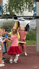 Children celebrate with party hats at Moscow playground