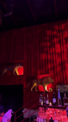Red-themed NYC bar features animal statues and disco ball