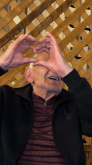 Elderly man makes heart gestures at Yerevan restaurant gathering