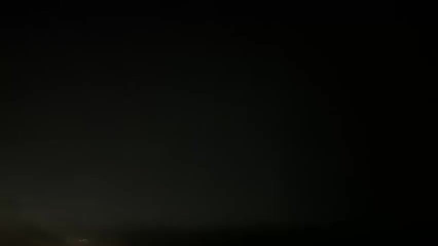 The video shows a dark, overcast sky with some light breaking through on the left side. As the video progresses, the sky becomes completely dark, indicating either nighttime or a severe storm. There are no people or objects visible in the frame. The overall impression is of a rapidly darkening sky, possibly due to an approaching storm.