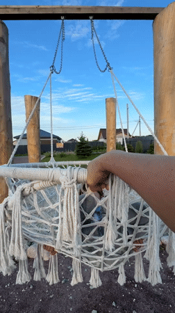 Kid, macrame swing, and two big dogs at a Russian dacha