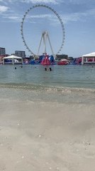 Beach swimmers enjoy clear waters in Dubai morning scene