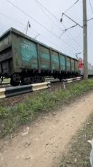 Freight train with colored hopper cars observed in Bira, Russia