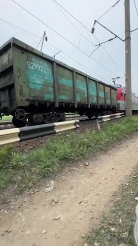 Freight train with colored hopper cars observed in Bira, Russia