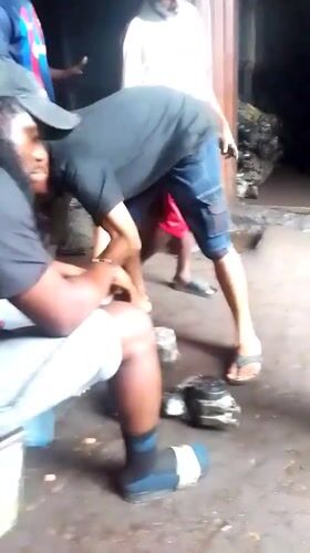 Auto repair work and gas station activity in Onitsha