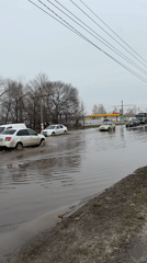 Vehicles navigate flooded streets in Ulyanovsk during spring flooding
