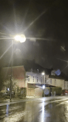 Rainy night street scene captured in Sanem, Luxembourg