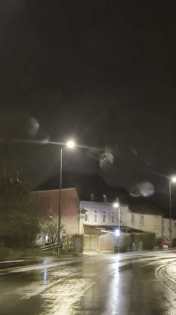 Rainy night street scene captured in Sanem, Luxembourg