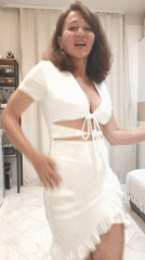 Dancing in a white dress inside a Sochi apartment