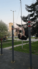 Man performs muscle-up exercise at Ruse park fitness equipment