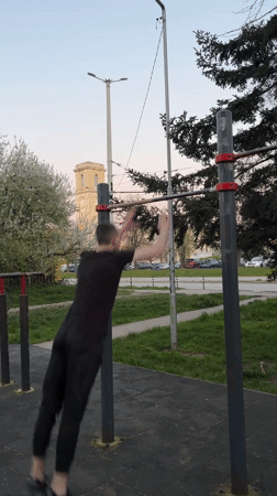 Man performs muscle-up exercise at Ruse park fitness equipment