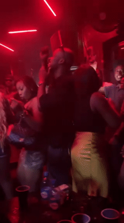 Lagos nightclub packed with dancers under red lights