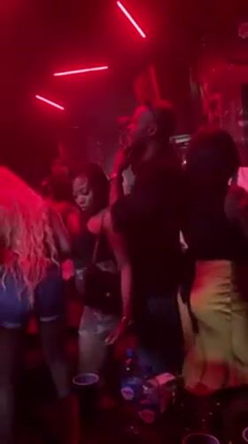 Lagos nightclub packed with dancers under red lights