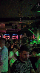 Neon skeletons and a live performer light up a Sozopol nightclub