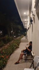Nighttime stroll around a lit waterway in Ciawi