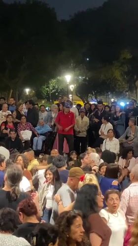 Nighttime street performance draws crowd in Miraflores, Peru