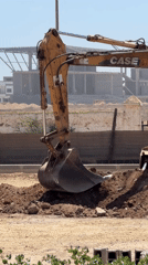 Construction excavator operates at El Jadida site under clear skies
