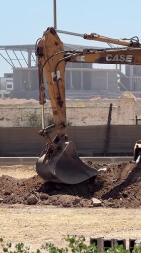 Construction excavator operates at El Jadida site under clear skies