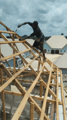 Construction worker builds roof frame in Agbarha-Otor, Nigeria