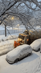Snow plow clears residential New York street amid winter weather