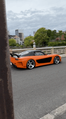 Modified orange Mazda RX-7 spotted parked on Osaka bridge