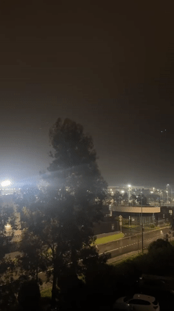Foggy night scene captured near lit building in Sirius, Russia