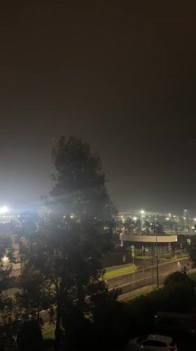 Foggy night scene captured near lit building in Sirius, Russia