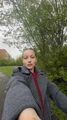 Woman walks baby through park in Reshetnikovo, Russia