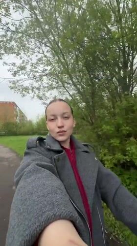 Woman walks baby through park in Reshetnikovo, Russia