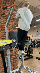 Woman performs assisted pull-ups at Chaikovsky gym