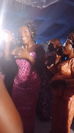 Celebration with dancing women in pink dresses captured in Abuja