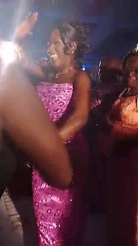 Celebration with dancing women in pink dresses captured in Abuja