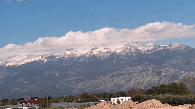 Snow-covered mountains viewed from Seydikemer under blue skies