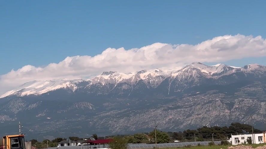 Snow-covered mountains viewed from Seydikemer under blue skies