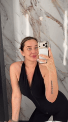 Woman takes bathroom selfies in Moscow wearing black jumpsuit