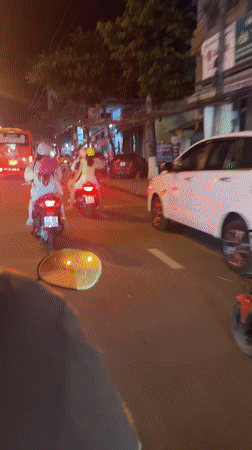 Scooter rider travels through Nha Trang streets at night