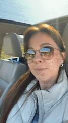 Woman enjoys music in car with sunroof in Riga