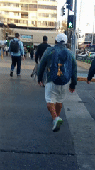 Pedestrians navigate busy Santiago streets on sunny afternoon